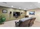 Cozy living room features a large screen TV, comfortable seating, and neutral carpet at 2231 E 128Th Ave, Thornton, CO 80241