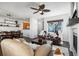 Open-concept living space with hardwood flooring, comfortable seating, and direct view to the kitchen at 2231 E 128Th Ave, Thornton, CO 80241