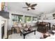 Spacious living room and dining area with hardwood floors, comfortable seating, and modern light fixtures at 2231 E 128Th Ave, Thornton, CO 80241