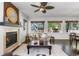 Cozy living room featuring a fireplace, large windows, and a comfortable sofa at 2231 E 128Th Ave, Thornton, CO 80241