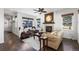Open floor plan showcasing the living room with a fireplace, hardwood floors, and comfortable furnishings at 2231 E 128Th Ave, Thornton, CO 80241