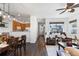 Open floor plan of living room and dining area with hardwood floors and view into kitchen at 2231 E 128Th Ave, Thornton, CO 80241