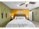 Comfortable main bedroom featuring a ceiling fan, decorative pillows, and warm, colorful walls at 2231 E 128Th Ave, Thornton, CO 80241