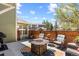 Patio with outdoor seating, fire pit, colorful rug, and partial fence for privacy at 2231 E 128Th Ave, Thornton, CO 80241