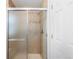 Shower featuring sliding doors, neutral tile, and a handheld shower head at 2231 E 128Th Ave, Thornton, CO 80241