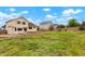 Expansive backyard with green grass, patio, and a wood fence at 4873 Eckert St, Castle Rock, CO 80104