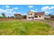 Wide backyard with green grass, a patio, and a wood fence at 4873 Eckert St, Castle Rock, CO 80104
