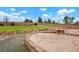 Spacious backyard with a sandbox, green grass, and a wood fence in the distance at 4873 Eckert St, Castle Rock, CO 80104