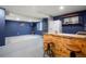 Basement bar and rec room area with TV, space to entertain, a ladder, and a fridge at 4873 Eckert St, Castle Rock, CO 80104