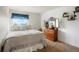 Cozy bedroom with carpet, a large dresser with mirror, and a window with a view to the neighborhood at 4873 Eckert St, Castle Rock, CO 80104