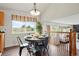 Bright dining area featuring laminate wood floors, a round table with black chairs, and view to backyard at 4873 Eckert St, Castle Rock, CO 80104