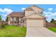 Charming two-story home featuring stone accents, a covered porch, and an attached two car garage at 4873 Eckert St, Castle Rock, CO 80104