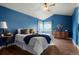 Bright main bedroom featuring wood floors, a ceiling fan, vaulted ceilings, and two large windows at 4873 Eckert St, Castle Rock, CO 80104