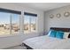 Bedroom with large windows offering natural light and neighborhood views at 10627 Rutledge St, Parker, CO 80134