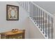 Elegant staircase with white banister and black metal spindles, complemented by decorative mirror at 10627 Rutledge St, Parker, CO 80134