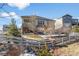 View of the backyard with a retaining wall, a small yard, and a split rail fence in the distance at 15994 La Plata Peak Pl, Broomfield, CO 80023