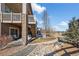 View of the backyard including the stairs to the upper deck, small yard and a rocky drainage area at 15994 La Plata Peak Pl, Broomfield, CO 80023