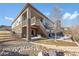 Backyard view of the home's outdoor living spaces including the patio, yard and stone accents at 15994 La Plata Peak Pl, Broomfield, CO 80023