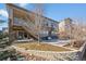 A view of the backyard including the retaining wall, small yard, and the staircase to the covered deck at 15994 La Plata Peak Pl, Broomfield, CO 80023
