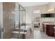 Bathroom featuring a tiled tub with a glass shower, and dual sink vanity at 15994 La Plata Peak Pl, Broomfield, CO 80023