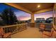 Relaxing covered porch with wood flooring and stone supports provides spectacular views of the outdoors at 15994 La Plata Peak Pl, Broomfield, CO 80023