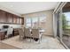 Bright dining room featuring a large table, built-in cabinets, and a sliding glass door to a private balcony at 15994 La Plata Peak Pl, Broomfield, CO 80023