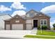 Charming two-story home featuring a three-car garage, stone accents, and well-kept landscaping, inviting curb appeal at 15994 La Plata Peak Pl, Broomfield, CO 80023