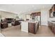 Open-concept kitchen seamlessly flowing into a living room, offering great connectivity and entertaining space at 15994 La Plata Peak Pl, Broomfield, CO 80023