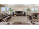 Expansive living room with comfortable seating, entertainment center, and large windows, creating a cozy atmosphere at 15994 La Plata Peak Pl, Broomfield, CO 80023