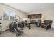 Home office featuring an elliptical machine, desk, computer, cabinets, and a comfortable chair at 15994 La Plata Peak Pl, Broomfield, CO 80023