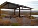 A covered picnic pavilion with seating near a pond, with a backdrop of scenic views at 15994 La Plata Peak Pl, Broomfield, CO 80023