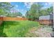 Spacious backyard featuring lush green grass and a wood fence, perfect for outdoor activities at 13245 Shoshone St, Denver, CO 80234