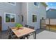 A patio has an outdoor dining table, greenery, and is a great space for outdoor relaxation at 13245 Shoshone St, Denver, CO 80234