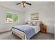 A bedroom filled with natural light features a ceiling fan, a large window, and neutral decor at 13245 Shoshone St, Denver, CO 80234