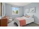 Cozy bedroom featuring a beanbag chair, bright walls, and natural light from the large window at 13245 Shoshone St, Denver, CO 80234