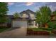 Charming two-story home with a well-manicured front yard, a porch, and an attached garage at 13245 Shoshone St, Denver, CO 80234