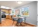 Sunny kitchen featuring stainless appliances, wooden cabinets, and a dining nook with a view at 13245 Shoshone St, Denver, CO 80234