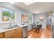 Well-lit kitchen with stainless steel appliances, hardwood floors, and eat-in dining area at 13245 Shoshone St, Denver, CO 80234