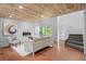 Bright living room featuring a wood ceiling, hardwood floors, and modern fireplace at 13245 Shoshone St, Denver, CO 80234