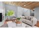 Bright living area with a striking wood ceiling, modern décor, and a staircase at 13245 Shoshone St, Denver, CO 80234