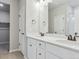 Bathroom with a double vanity with a granite countertop and white cabinetry at 18308 Martinello Dr, Parker, CO 80134