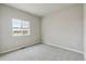 Bright bedroom with a large window and neutral carpet at 18308 Martinello Dr, Parker, CO 80134