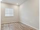 Bedroom featuring natural light from the window and luxury vinyl plank flooring at 18308 Martinello Dr, Parker, CO 80134