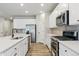 Modern kitchen featuring stainless steel appliances, gas range, tile backsplash and white cabinets at 18308 Martinello Dr, Parker, CO 80134