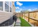 Cozy backyard with artificial turf, privacy fence, and walkway to the gate on a sunny day at 14096 Red Cosmos St, Parker, CO 80134