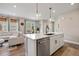 Stylish open-concept kitchen boasts an island, stainless steel dishwasher, and seamless connection to the living space at 14096 Red Cosmos St, Parker, CO 80134