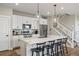 Bright kitchen with white cabinets, stainless steel appliances, large island and pendant lighting at 14096 Red Cosmos St, Parker, CO 80134