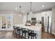 Beautiful kitchen featuring white cabinets, stainless steel appliances, and a spacious island with bar stool seating at 14096 Red Cosmos St, Parker, CO 80134