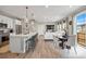Open-concept living space featuring a modern kitchen, dining area, living room, and sliding door to the backyard at 14096 Red Cosmos St, Parker, CO 80134