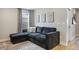 Cozy living room with a plush sectional sofa, accent pillows, and modern decor at 14096 Red Cosmos St, Parker, CO 80134